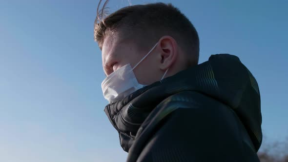 Guy in a Protective Mask Stays on the Street. Prevention and Protection of Health and Life Safety