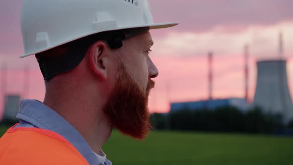 Portrait of a Male Engineer on the Background of a Power Plant alt