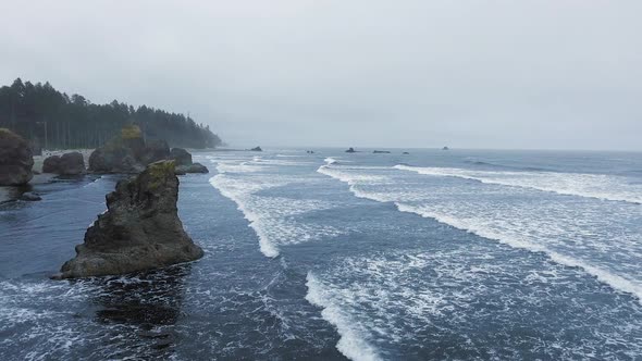 Aerial shot of ocean waves breaking on rocks at Ruby Beach, Olympic National Park, Washington, USA alt