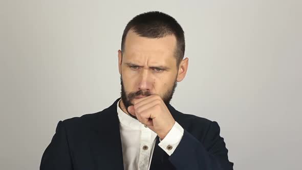 Young Handsome Businessman Coughs Badly and Feels Sick. A Young Successful Businessman Coughs at a alt