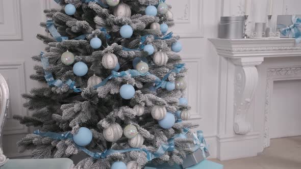 Presents under the Christmas tree. Beautifully packaged blue boxes. alt