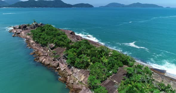 Aerial drone view of Fortaleza Beach, Ubatuba - São Paulo. Beautiful Crashing waves in a rocky coast alt