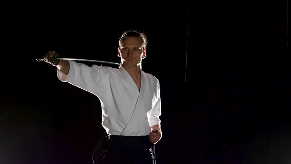 Man Fighting at Aikido Training with Japanese Sword Katana in Martial Arts School. Healthy Lifestyle alt