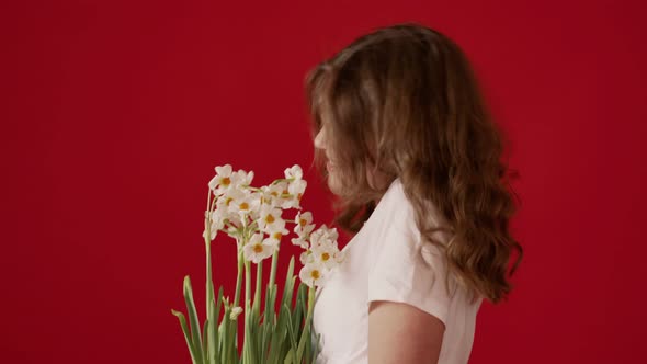 Young Woman Enjoying White Flowers