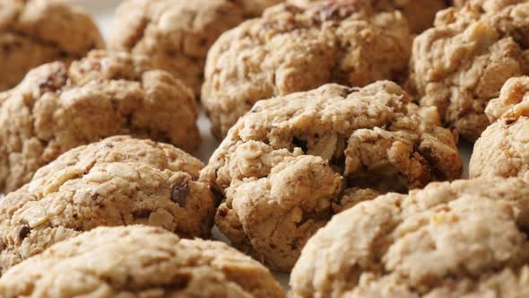 Tasty oatmeal biscuits served on plate shallow DOF 4K 2160p 30fps UHD panning footage - Pile of home alt