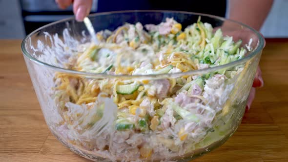 Woman Chef Mixes Fresh Vegetable Salad with Chicken alt