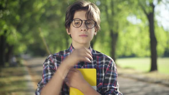 Intelligent Nerd Teenage Boy Adjusting Eyeglasses Looking at Camera ...