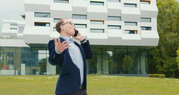 The Businessman is Talking on the Phone and is Very Happy alt