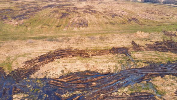 Scattered Heaps of Manure on an Agricultural Field Aerial View alt