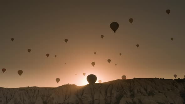 Hot Air Balloons Flying Over Valley at Sunrise in Cappadocia