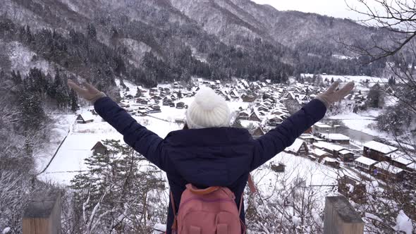 Young woman traveler enjoying with snow at shirakawa-go in winter