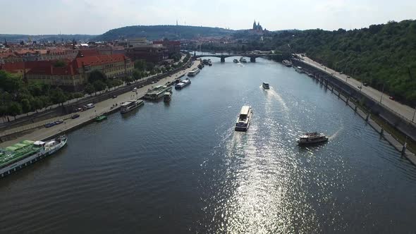Aerial of Vltava River with boats and a bridge
