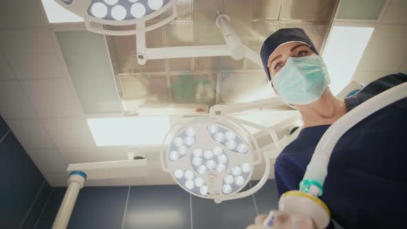 Low angle view of young anesthesiologist at work alt