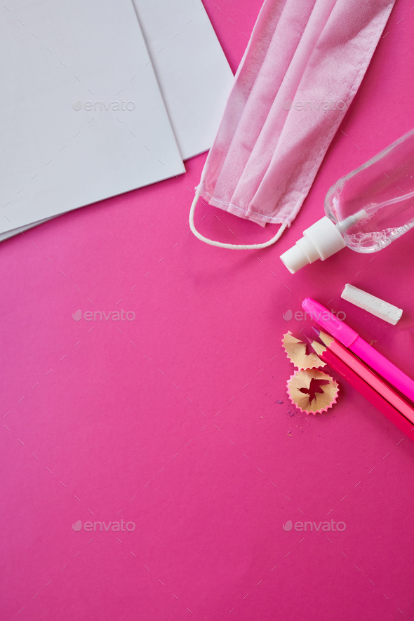 School supplies, protective mask and antiseptic on a pink background - Stock Photo - Images