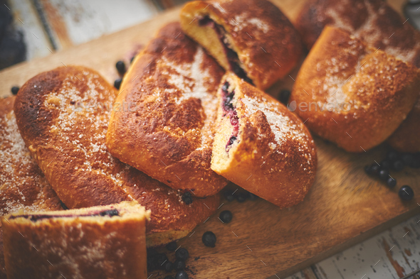 Tasty blueberry bun stuffed with fresh forrest fruits. Traditional polish bun called jagodzianka - Stock Photo - Images
