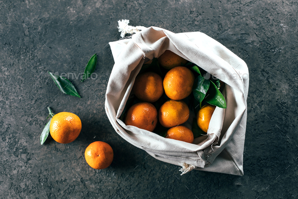 Ripe mandarine tangerine in cotton bag. Zero waste concept - Stock Photo - Images