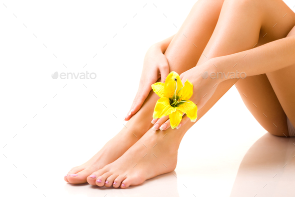 Beautiful well-groomed legs of girl with a flower - Stock Photo - Images