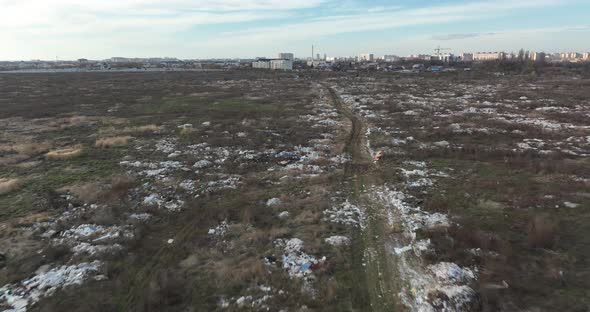 Two People Walking on a Huge Aste Garbade Dump Rubbish Landill in Bucharest