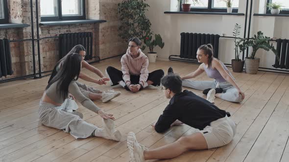Students Stretching in Dance Studio alt