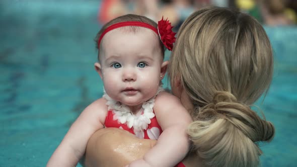 Mother with a Baby in the Pool alt