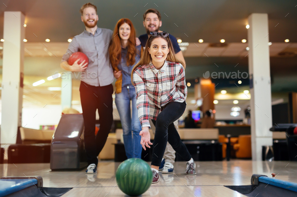 Friends enjoying bowling at club