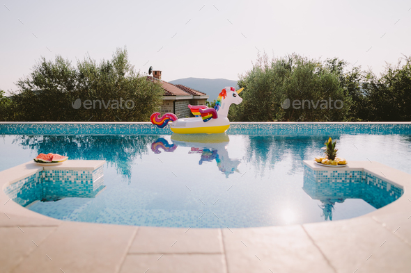 beautiful swimming pool with inflatable toy pool floating unicorn
