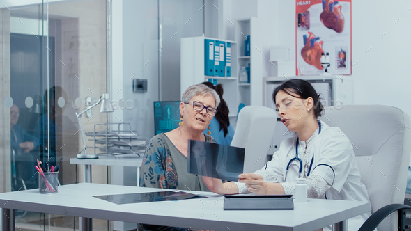 Doctor using x-rays to consult with patient - Stock Photo - Images