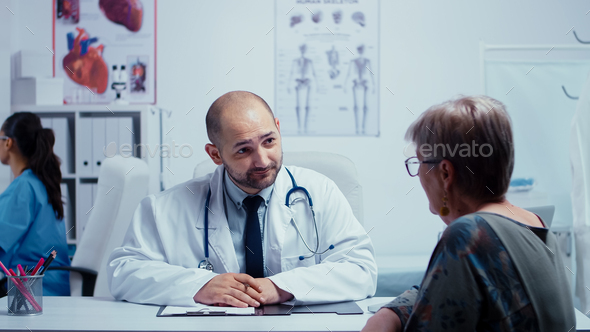 Male doctor interviewing an elderly woman
