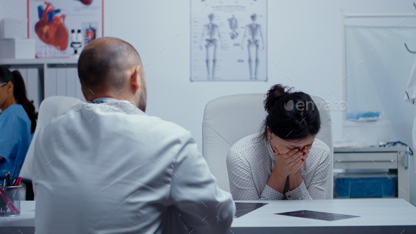 Woman crying at doctor after bad news