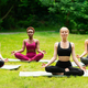 Outdoor yoga class. Group of diverse girls doing breathing exercises or  meditation in nature Stock Photo by Prostock-studio