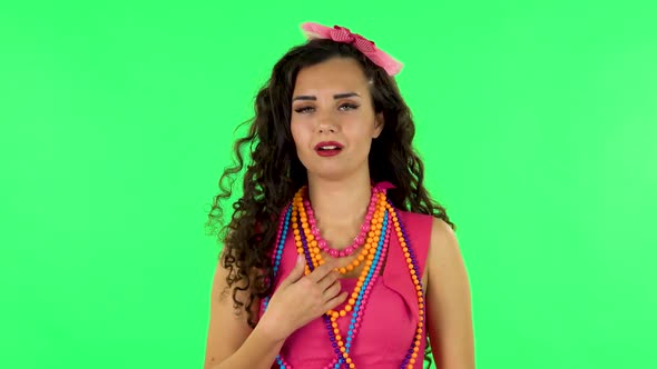 Indignant Woman Throwing Up Hands Expressing She Is Innocent, Twists His Finger at His Temple. Green alt