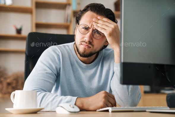 Image of brooding bearded programmer man working with computer Stock ...