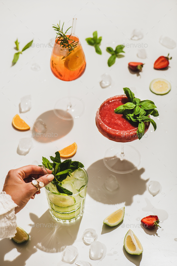 Poplular summer alcohol cocktails and womans hand with mint - Stock Photo - Images