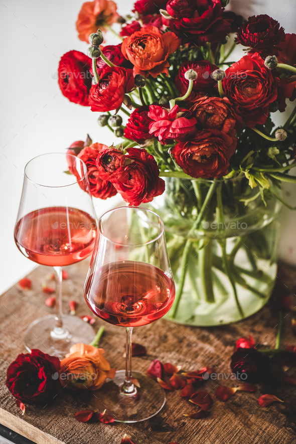 Rose wine in glasses and red spring flowers - Stock Photo - Images