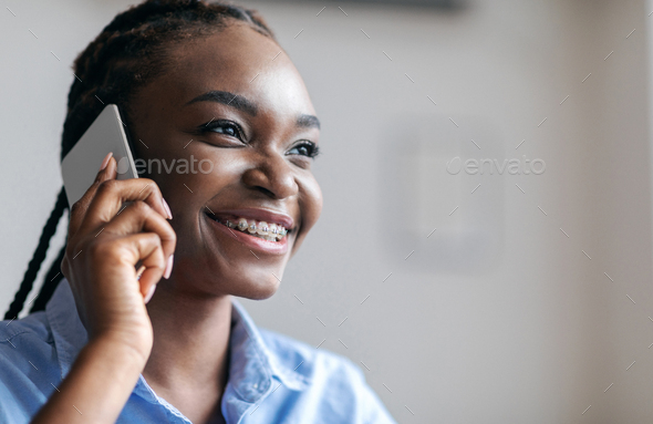 Phone Call. Portrait of cheerful black woman talking on cellphone, enjoying conversation