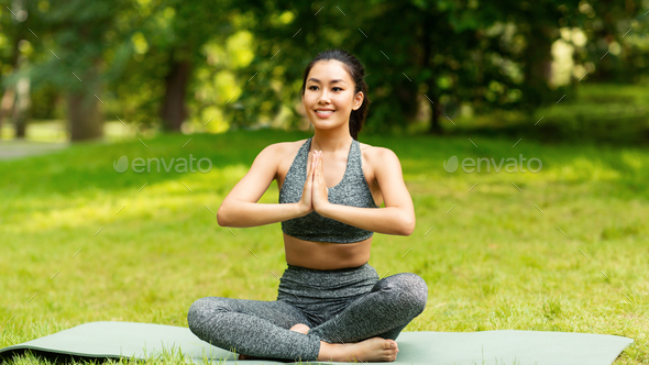 Calm business woman meditating in lotus outdoors, peaceful female