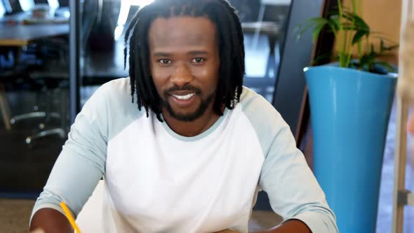 Executive smiling at the camera alt