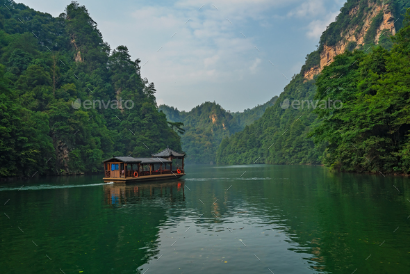 Tourist boat sailing among karst landscape on Baofeng Lake - Stock Photo - Images