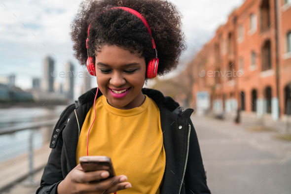 Woman with mobile phone and headphones - Stock Photo - Images