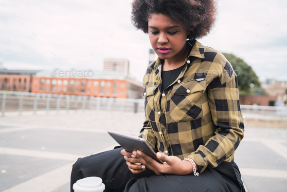 Afro american latin woman using digital tablet