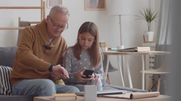 Old Man Mastering Gadgets with Kid Help alt