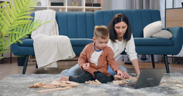 Small Boy Sitting at His Workplace and Drawing Elementary Picture with Felt-tip Pens alt