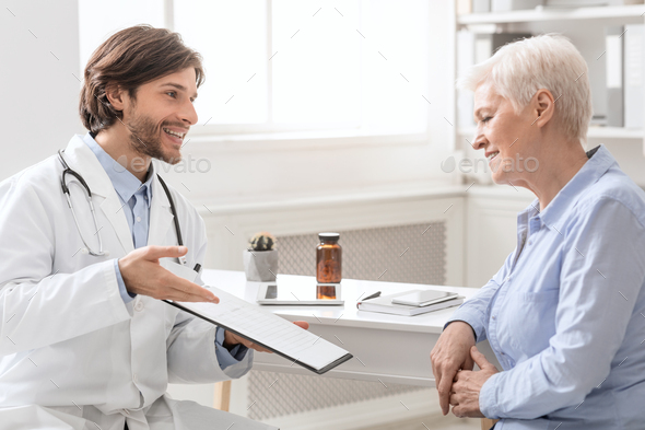 Cheerful doctor explaining treatment plan to senior female patient