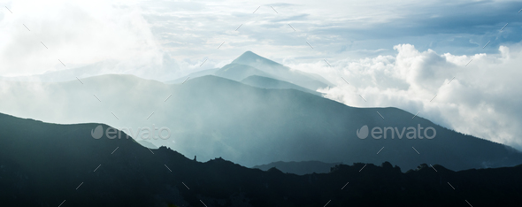 Panorama of beauty blue foggy mountains range