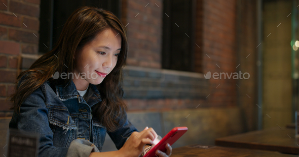 Woman use of mobile phone for order food in restaurant
