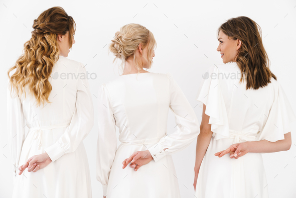 Photo from back of three women with fingers crossed for good luck