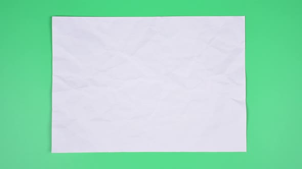 Crumpled wrinkled sheet of paper background texture. Stop motion animation. Seamless looping.