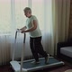 Old Woman Runs on a Treadmill at Home - VideoHive Item for Sale