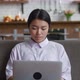 Asian Woman Resting on Couch Using Laptop Notebook Looking at Screen Typing Message at Living Room - VideoHive Item for Sale