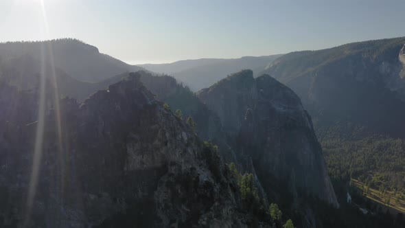 Scenic Aerial Survey Over the Yosemite National Park Lit with Bright Sunset Rays alt